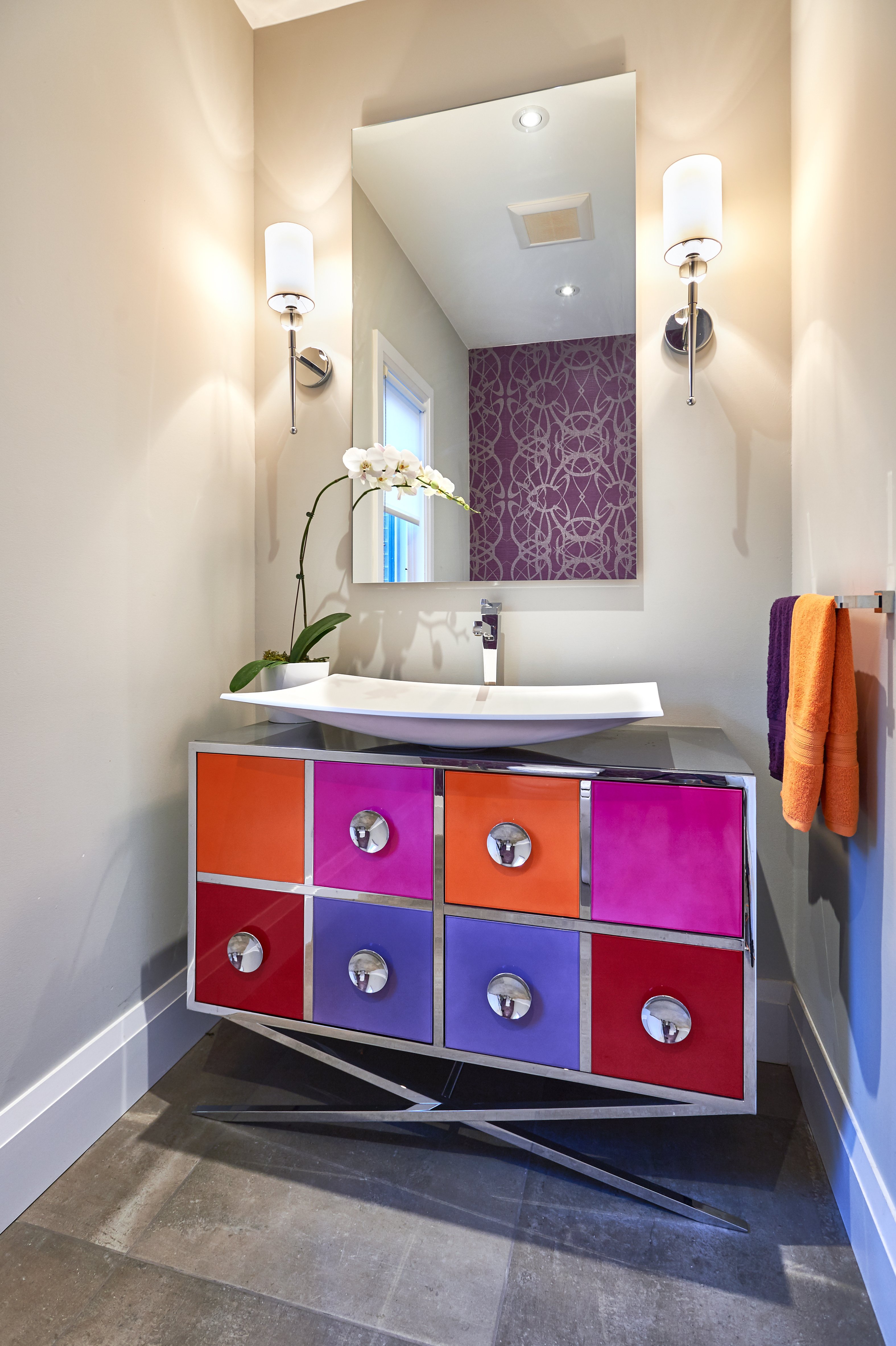 A vibrant bathroom featuring a colorful vanity and mirror, showcasing Golden Bee Homes' stylish renovation materials.